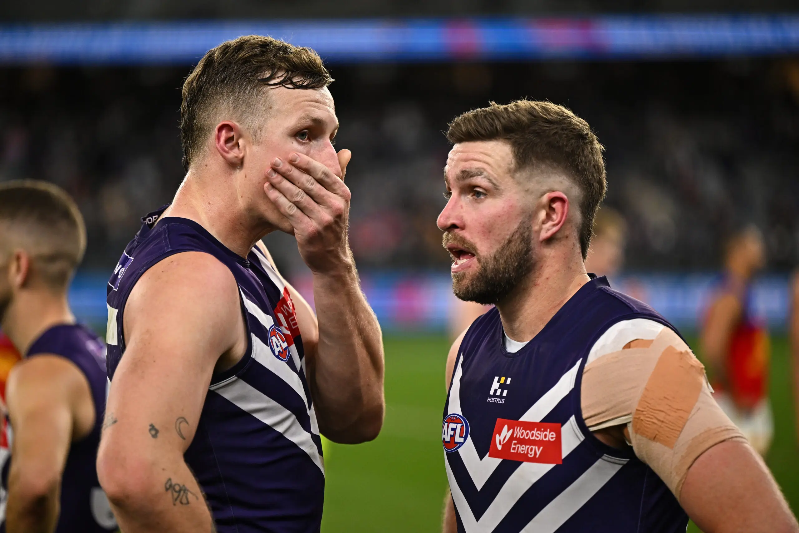 PERTH, AUSTRALIA - AUGUST 15: Josh Treacy and Luke Ryan of the Dockers look dejected after a loss during the 2025 AFL Round 23 match between the Fremantle Dockers and the Brisbane Lions at Optus Stadium on August 15, 2025 in Perth, Australia. (Photo by Daniel Carson/AFL Photos via Getty Images)
