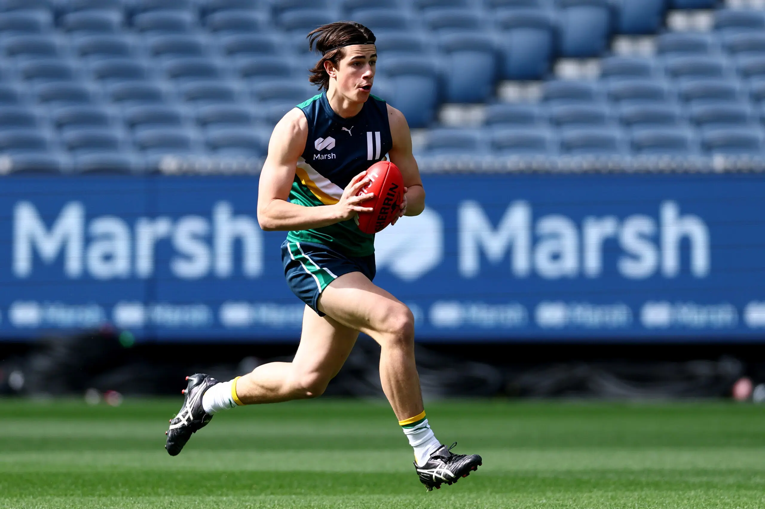 MELBOURNE, AUSTRALIA - SEPTEMBER 27: Gus Kennedy of Team Docherty runs with the ball during the Marsh AFL National Futures Boys match between Team Boak and Team Docherty at Melbourne Cricket Ground, on September 27, 2025 in Melbourne, Australia. (Photo by Josh Chadwick/AFL Photos/via Getty Images)
