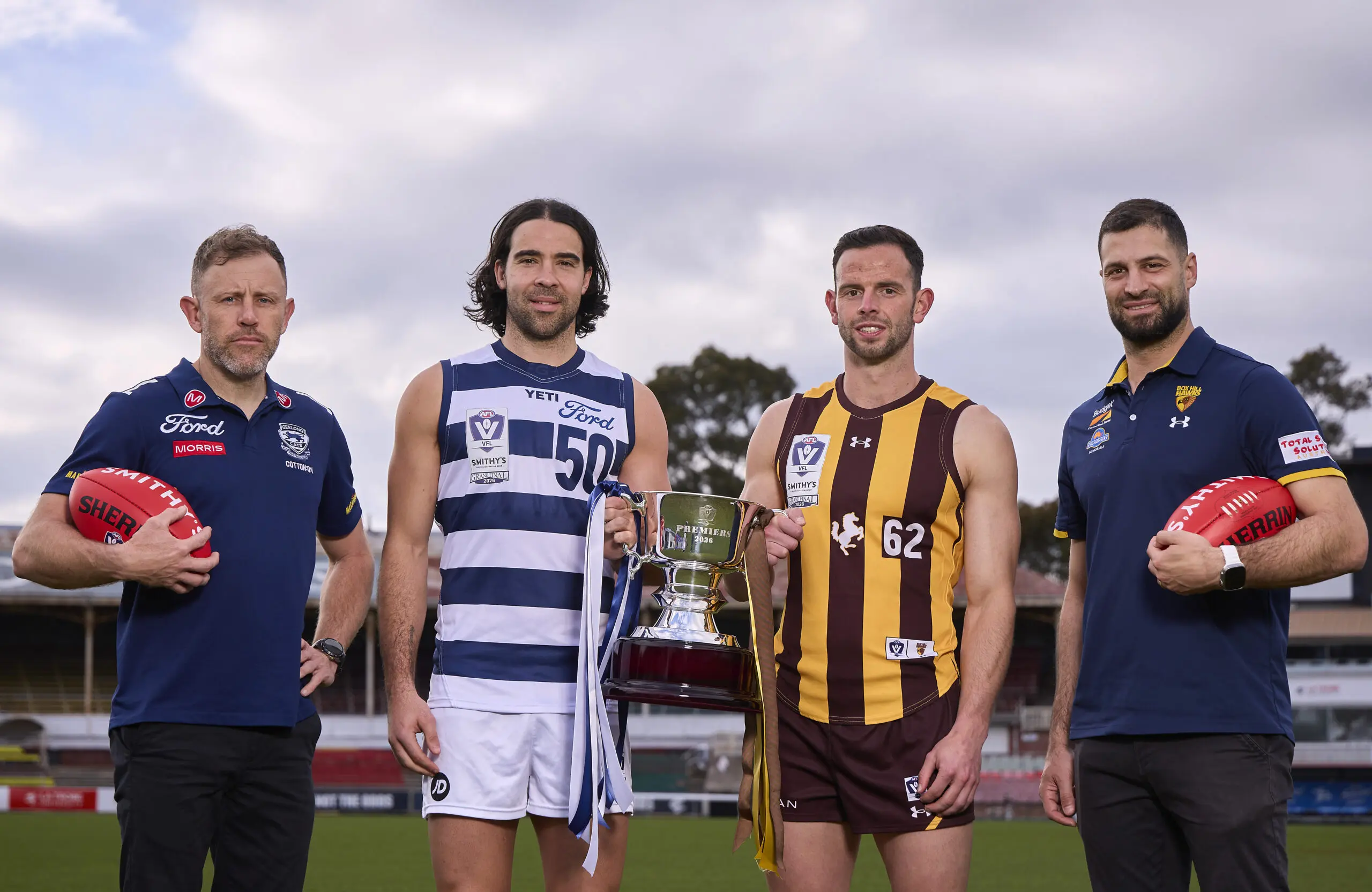 MELBOURNE, AUSTRALIA - SEPTEMBER 14: (L-R) Geelong Cats Senior Coach Mark Corrigan, Dan Capiron of Geelong Cats, Stu Horner of Box Hill Hawks and Box Hill Hawks Senior Coach David Mirra pose during the 2026 VFL/VFLW Grand Final Media Opportunity at Ikon Park on September 14, 2026 in Melbourne, Australia. (Photo by Graham Denholm/AFL Photos via Getty Images)