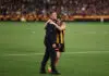 Seething Sam Mitchell praises Hawks stars and flags trade moves after prelim pain MELBOURNE, AUSTRALIA - SEPTEMBER 19: Sam Mitchell, Senior Coach of the Hawks and Nick Watson embrace during the 2026 AFL First Preliminary Final between the Hawthorn Hawks and the Brisbane Lions at the Melbourne Cricket Ground on September 19, 2026 in Melbourne, Australia. (Photo by James Wiltshire/AFL Photos via Getty Images)