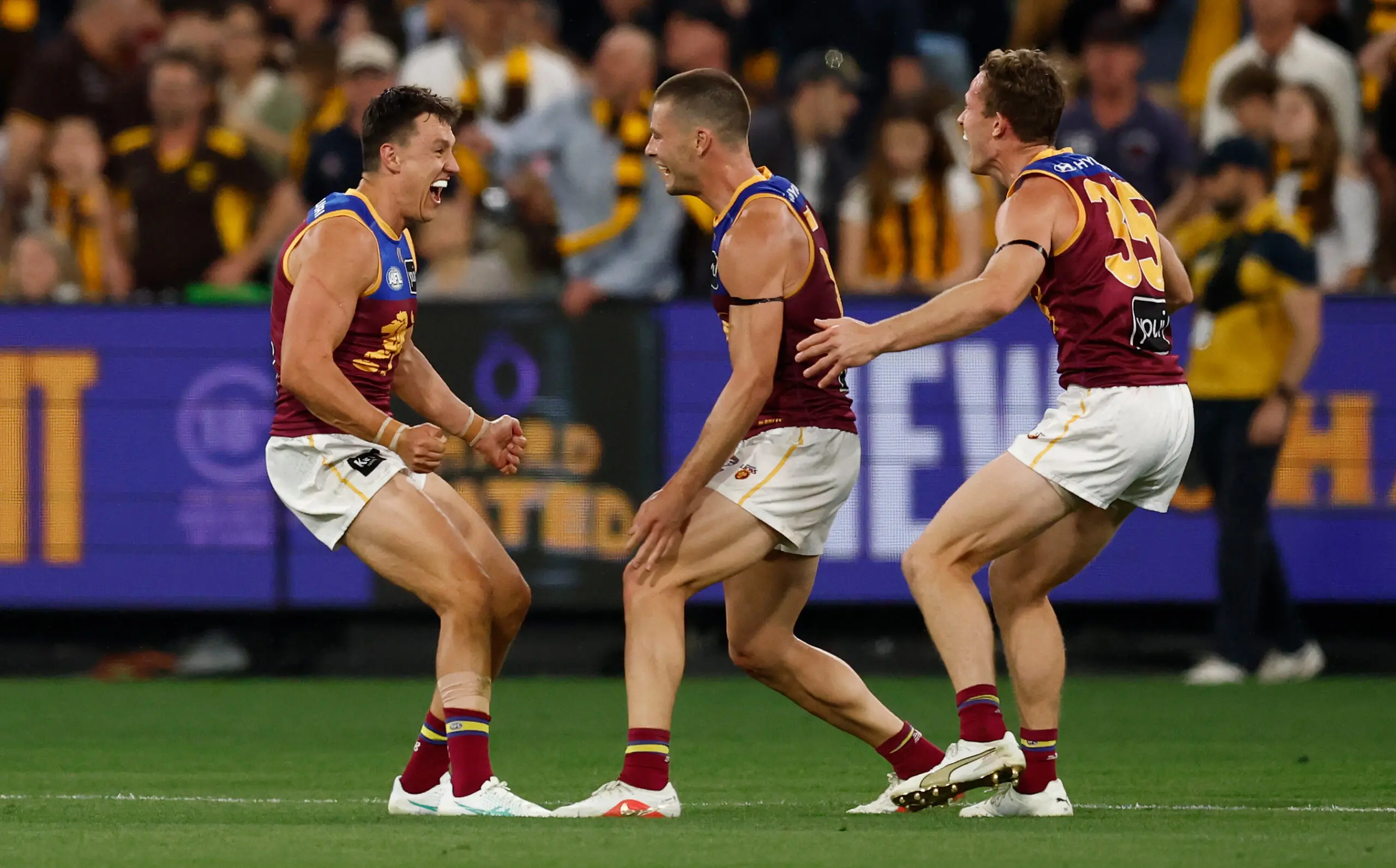 MELBOURNE, AUSTRALIA - SEPTEMBER 19: (L-R) Hugh McCluggage, Josh Dunkley and Ryan Lester of the Lions celebrate during the 2026 AFL First Preliminary Final between the Hawthorn Hawks and the Brisbane Lions at the Melbourne Cricket Ground on September 19, 2026 in Melbourne, Australia. (Photo by Michael Willson/AFL Photos via Getty Images)