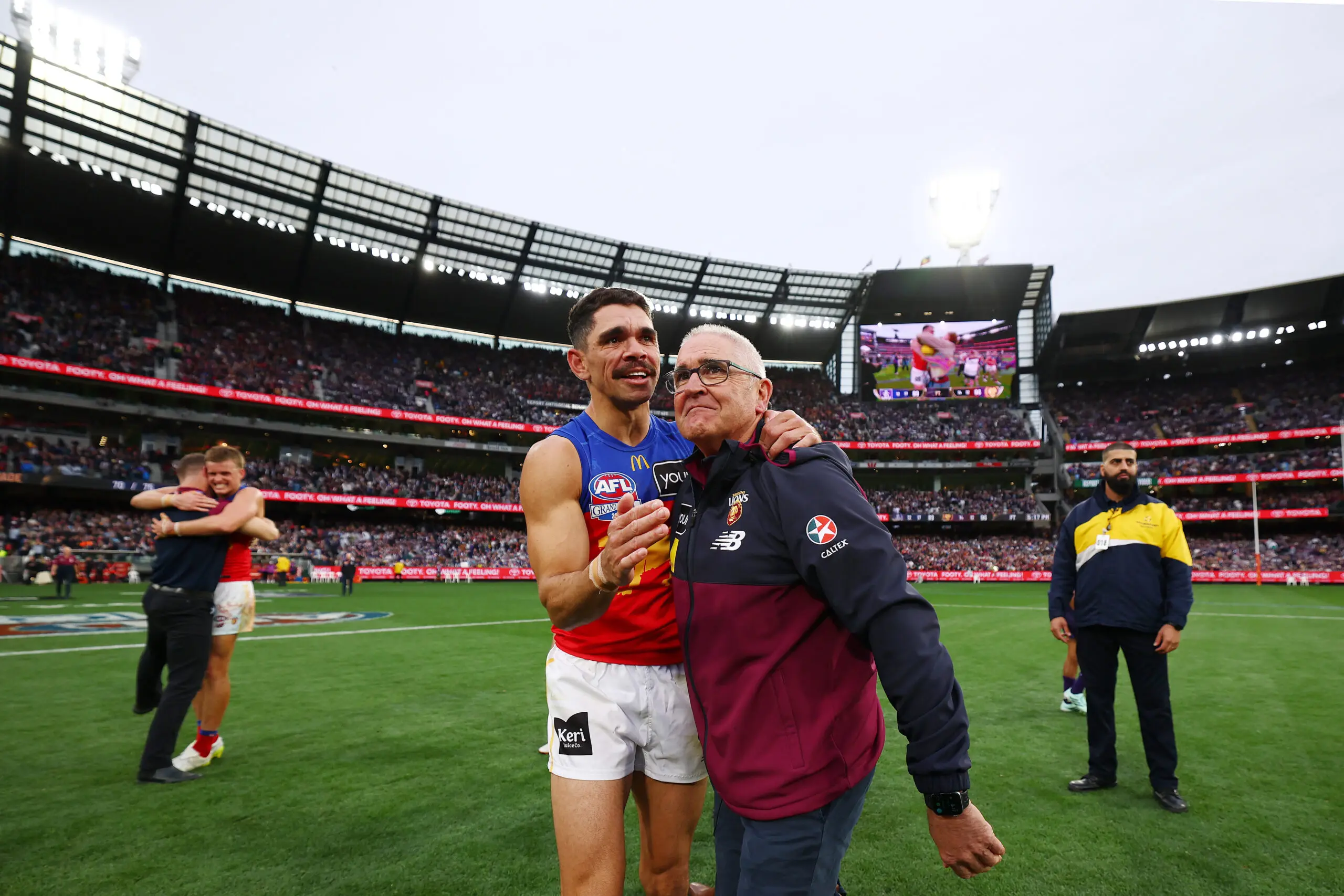 MELBOURNE, AUSTRALIA - SEPTEMBER 26: Charlie Cameron of the Lions and Chris Fagan, Senior Coach of the Lions celebrate victory after winning the AFL Grand Final match between Fremantle Dockers and Brisbane Lions at Melbourne Cricket Ground, on September 26, 2026, in Melbourne, Australia. (Photo by Morgan Hancock/AFL Photos/via Getty Images)