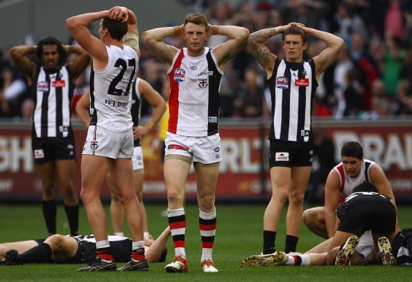 MELBOURNE, AUSTRALIA - SEPTEMBER 25: Jason Blake and Brendon Goddard of the Saints and Dayne Beams of the Magpies react as the siren sounds at the end of the game and it is a draw during the AFL Grand Final match between the Collingwood Magpies and the St Kilda Saints at the Melbourne Cricket Ground on September 25, 2010 in Melbourne, Australia. (Photo by Quinn Rooney/Getty Images)