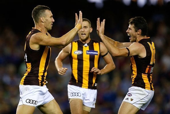 MELBOURNE, AUSTRALIA - APRIL 10: (L-R) Jonathon Ceglar, Jonathan O'Rourke and Isaac Smith of the Hawks celebrate during the 2016 AFL Round 03 match between the Western Bulldogs and the Hawthorn Hawks at Etihad Stadium, Melbourne on April 10, 2016. (Photo by Michael Willson/AFL Media/Getty Images)