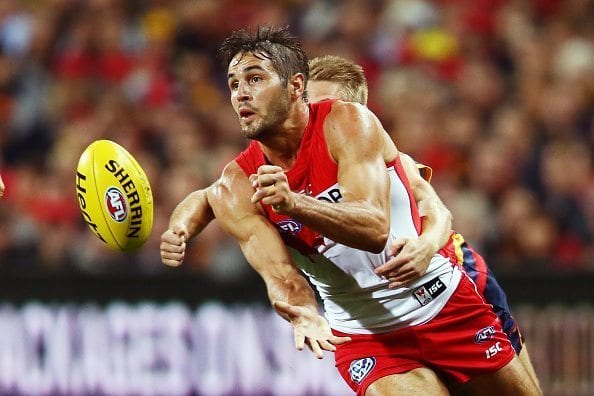 ADELAIDE, AUSTRALIA - APRIL 16: Josh Kennedy of the Swans gets away from David Mackay of the Crows during the round four AFL match between the Adelaide Crows and the Sydney Swans at Adelaide Oval on April 16, 2016 in Adelaide, Australia. (Photo by Morne de Klerk/Getty Images)