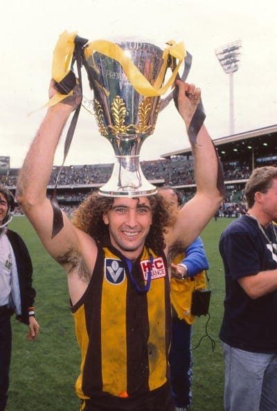 MELBOURNE, AUSTRALIA - SEPTEMBER 25: John Platten of the Hawks celebrates with the trophy after winning the 1988 VFL Grand Final match between Hawthorn Hawks and Melbourne Demons at the Melbourne Cricket Ground on September 25, 1988 in Melbourne, Australia. (Photo by Getty Images)