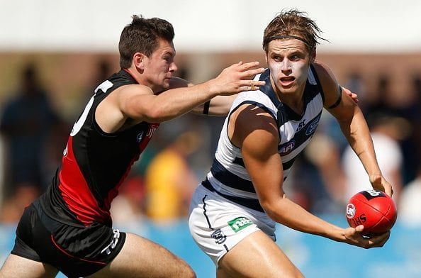 SHEPPARTON, AUSTRALIA - MARCH 5: Jake Kolodjashnij of the Cats is tackled by Conor McKenna of the Bombers during the 2016 NAB Challenge match between the Essendon Bombers and the Geelong Cats at Deakin Reserve, Shepparton on March 5, 2016. (Photo by Michael Willson/AFL Media/Getty Images)