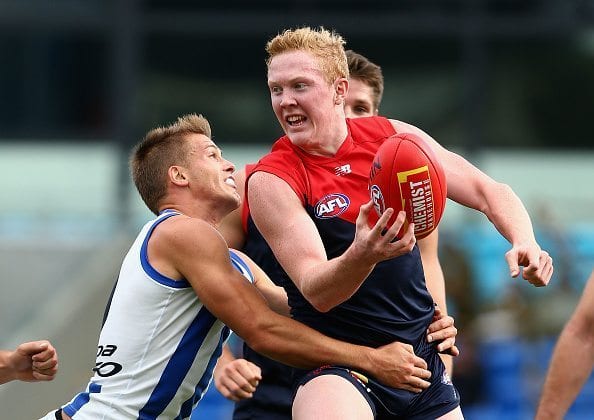 HOBART, AUSTRALIA - APRIL 10: Clayton Oliver of the Demons is tackled during the round three AFL match between the North Melbourne Kangaroos and the Melbourne Demons at Blundstone Arena on April 10, 2016 in Hobart, Australia. (Photo by Robert Prezioso/Getty Images)
