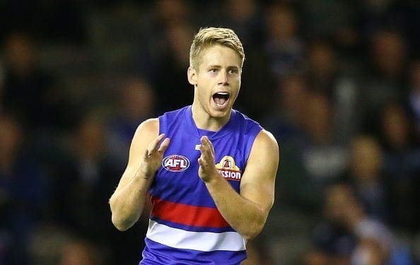 MELBOURNE, VICTORIA - APRIL 16:  Lachie Hunter of the Bulldogs kicks a goal during the round four AFL match between the Carlton Blues and the Western Bulldogs at Etihad Stadium on April 16, 2016 in Melbourne, Australia.  (Photo by Scott Barbour/AFL Media/Getty Images)