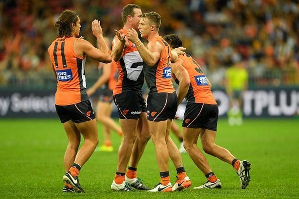 SYDNEY, AUSTRALIA - APRIL 30: Rhys Palmer of the Giants celebrates kicking a goal with team mates during the round six AFL match between the Greater Western Sydney Giants and the Hawthorn Hawks at Spotless Stadium on April 30, 2016 in Sydney, Australia. (Photo by Brett Hemmings/AFL Media/Getty Images)