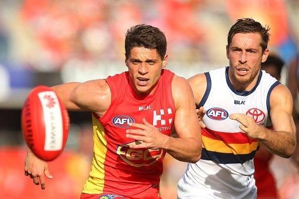 GOLD COAST, AUSTRALIA - MAY 21:  Dion Prestia of the Suns and Richard Douglas of the Crows compete for the ball during the round nine AFL match between the Gold Coast Suns and the Adelaide Crows at Metricon Stadium on May 21, 2016 in Gold Coast, Australia.  (Photo by Chris Hyde/Getty Images)