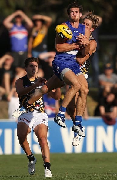 MELBOURNE, AUSTRALIA - FEBRUARY 28: Easton Wood of the Bulldogs competes for the ball against Reece McKenzie of the Tigers (R) during the NAB Challenge AFL match between the Western Bulldogs and the Richmond Tigers at Whitten Oval on February 28, 2015 in Melbourne, Australia. (Photo by Michael Dodge/Getty Images)