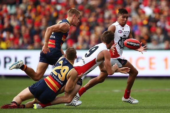 ADELAIDE, AUSTRALIA - APRIL 18: Ben Newton of the Demons passes the ball to Jay Kennedy-Harris of the Demons during the round three AFL match between the Adelaide Crows and the North Melbourne Kangaroos at Adelaide Oval on April 18, 2015 in Adelaide, Australia. (Photo by Morne de Klerk/Getty Images)