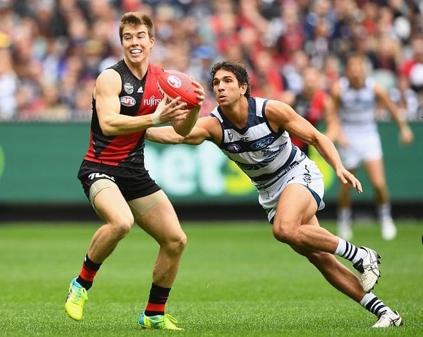 MELBOURNE, AUSTRALIA - APRIL 16: Zach Merrett of the Bombers is tackled by Nakia Cockatoo of the Cats during the round four AFL match between the Essendon Bombers and the Geelong Cats at Melbourne Cricket Ground on April 16, 2016 in Melbourne, Australia. (Photo by Quinn Rooney/Getty Images)