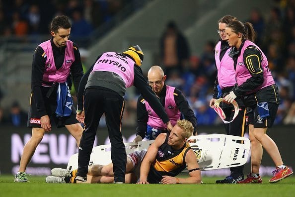 HOBART, AUSTRALIA - JUNE 03:  Steven Morris of the Tigers reacts after he suffers a leg injury in a contest with Robin Nahas of the Kangaroos during the round 11 AFL match between the North Melbourne Kangaroos and the Richmond Tigers at Blundstone Arena on June 3, 2016 in Hobart, Australia.  (Photo by Michael Dodge/Getty Images)