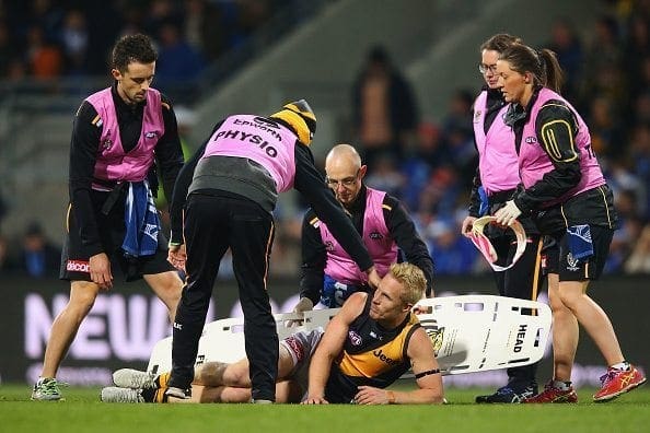 HOBART, AUSTRALIA - JUNE 03: Steven Morris of the Tigers reacts after he suffers a leg injury in a contest with Robin Nahas of the Kangaroos during the round 11 AFL match between the North Melbourne Kangaroos and the Richmond Tigers at Blundstone Arena on June 3, 2016 in Hobart, Australia. (Photo by Michael Dodge/Getty Images)