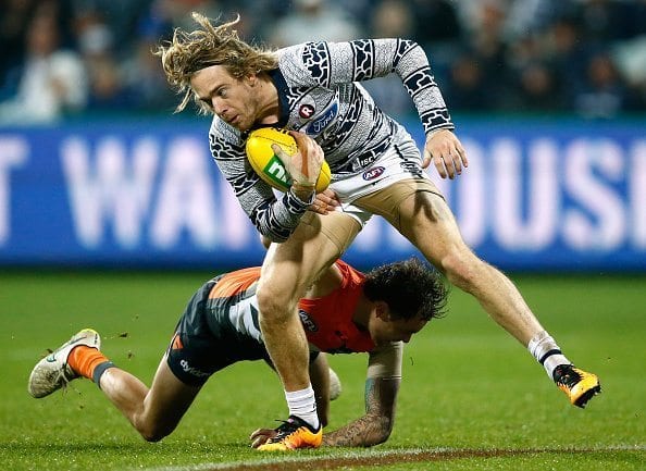 GEELONG, AUSTRALIA - JUNE 04: Cameron Guthrie of the Cats is tackled by Nathan Wilson of the Giants during the 2016 AFL Round 11 match between the Geelong Cats and the GWS Giants at Simonds Stadium on June 4, 2016 in Geelong, Australia. (Photo by Adam Trafford/AFL Media/Getty Images)