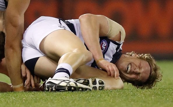 MELBOURNE, AUSTRALIA - JUNE 18: Josh Caddy of the Cats holds his knee during the 2016 AFL Round 13 match between the Western Bulldogs and the Geelong Cats at Etihad Stadium on June 18, 2016 in Melbourne, Australia. (Photo by Michael Willson/AFL Media/Getty Images)