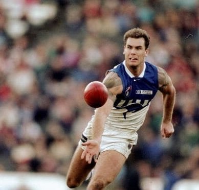 1990: Wayne Carey of North Melbourne in action during the Round 15 AFL Football match against St Kilda in Melbourne, Australia. Mandatory Credit: Hamish Blair /Allsport