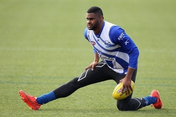 MELBOURNE, AUSTRALIA - JULY 16: Eric Wallace Stretches during a North Melbourne Kangaroos AFL media session at Arden Street Ground on July 16, 2014 in Melbourne, Australia. (Photo by Robert Prezioso/Getty Images)