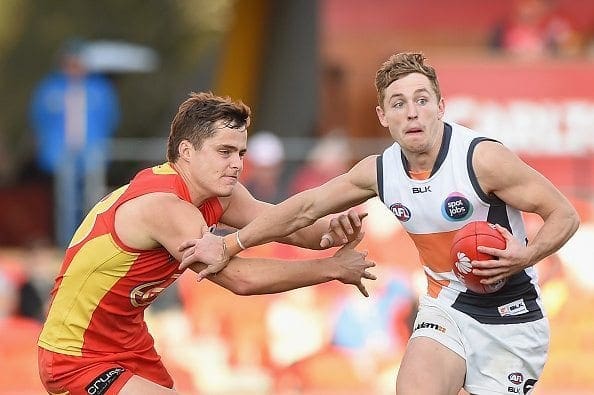 GOLD COAST, AUSTRALIA - JULY 18: Devon Smith of the Giants takes on the defence during the round 16 AFL match between the Gold Coast Suns and the Greater Western Sydney Giants at Metricon Stadium on July 18, 2015 on the Gold Coast, Australia. (Photo by Matt Roberts/Getty Images)