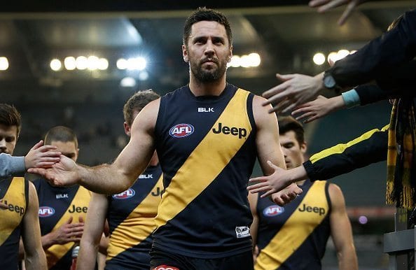 MELBOURNE, AUSTRALIA - JULY 25: Troy Chaplin of the Tigers leads the team off the field after his 200th game during the 2015 AFL round 17 match between the Richmond Tigers and the Fremantle Dockers at the Melbourne Cricket Ground, Melbourne, Australia on July 25, 2015. (Photo by Adam Trafford/AFL Media/Getty Images)