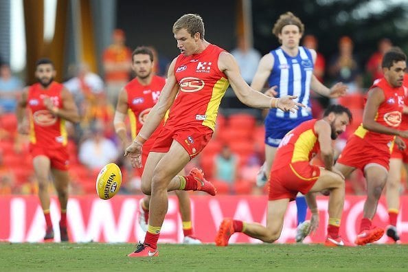 GOLD COAST, AUSTRALIA - APRIL 23: Sam Day of the Suns kicks during the round five AFL match between the Gold Coast Suns and the North Melbourne Kangaroos at Metricon Stadium on April 23, 2016 in Gold Coast, Australia. (Photo by Chris Hyde/Getty Images)