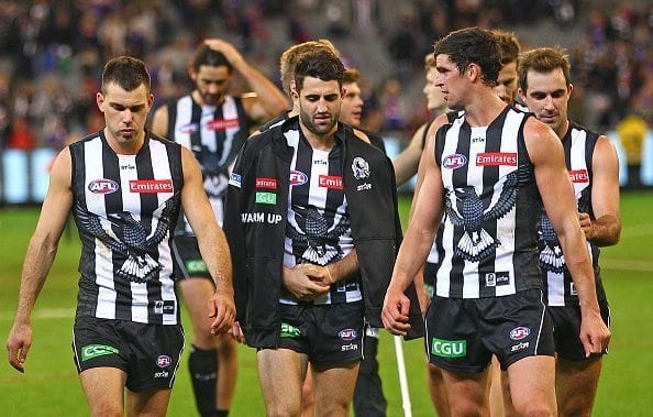 MELBOURNE, AUSTRALIA - MAY 29: Scott Pendlebury of the Magpies and his teammates incuding an injured Alex Fasolo of the Magpies leave the field after they lost the round 10 AFL match between the Collingwood Magpies and the Western Bulldogs at Melbourne Cricket Ground on May 29, 2016 in Melbourne, Australia. (Photo by Scott Barbour/Getty Images)