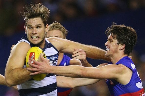 MELBOURNE, AUSTRALIA - JUNE 18: Tom Hawkins of the Cats is tackled by Jordan Kelly of the Bulldogs (R) during the round 13 AFL match between the Western Bulldogs and the Geelong Cats at Etihad Stadium on June 18, 2016 in Melbourne, Australia. (Photo by Michael Dodge/Getty Images)