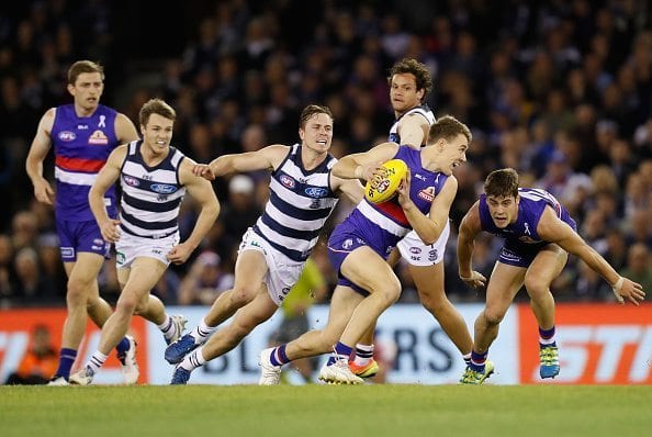 MELBOURNE, AUSTRALIA - JUNE 18: Jack Macrae of the Bulldogs is tackled by Mitch Duncan of the Cats during the 2016 AFL Round 13 match between the Western Bulldogs and the Geelong Cats at Etihad Stadium on June 18, 2016 in Melbourne, Australia. (Photo by Michael Willson/AFL Media/Getty Images)