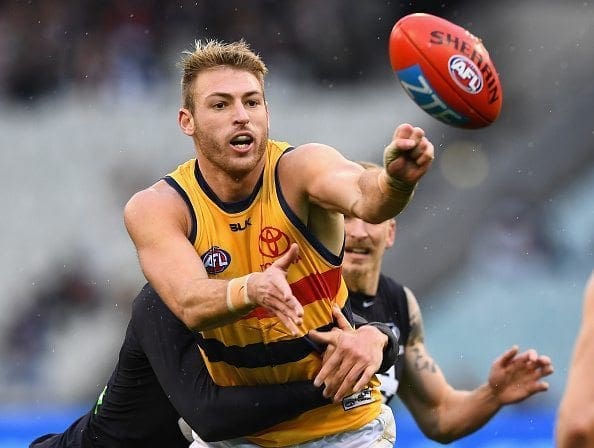 MELBOURNE, AUSTRALIA - JULY 10: Daniel Talia of the Crows handballs whilst being tackled by Jack Silvagni of the Blues during the round 16 AFL match between the Carlton Blues and the Adelaide Crows at Melbourne Cricket Ground on July 10, 2016 in Melbourne, Australia. (Photo by Quinn Rooney/Getty Images)