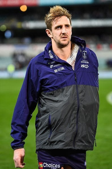 PERTH, AUSTRALIA - JULY 15: Michael Barlow of the Dockers leaves the field with his shoulder strapped during the 2016 AFL Round 17 match between the Fremantle Dockers and the Geelong Cats at Domain Stadium on July 15, 2016 in Perth, Australia. (Photo by Daniel Carson/AFL Media/Getty Images)