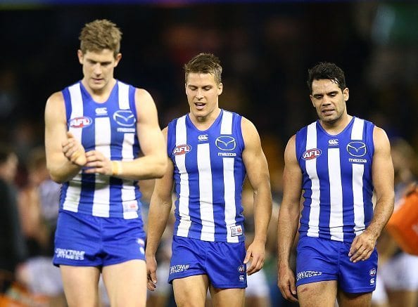 MELBOURNE, AUSTRALIA - JULY 16: Nick Dal Santo of the Kangaroos, Andrew Swallow of the Kangaroos and Daniel Wells of the Kangaroos leave the filed after losing the round 17 AFL match between the North Melbourne Kangaroos and the Port Adelaide Power at Etihad Stadium on July 16, 2016 in Melbourne, Australia. (Photo by Scott Barbour/Getty Images)