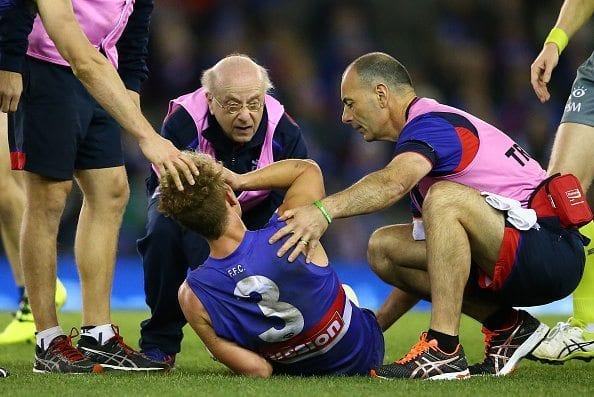 MELBOURNE, AUSTRALIA - JULY 23: Mitch Wallis of the Bulldogs leaves the field injured during the round 18 AFL match between the Western Bulldogs and the St Kilda Saints at Etihad Stadium on July 23, 2016 in Melbourne, Australia. (Photo by Scott Barbour/Getty Images)