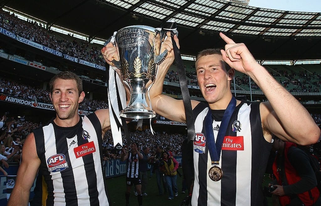 MELBOURNE, AUSTRALIA - OCTOBER 02:  Travis Cloke and Ben Reid of the Magpies celebrate with the Premiership Cup after the Magpies won the AFL Grand Final Replay match between the Collingwood Magpies and the St Kilda Saints at Melbourne Cricket Ground on October 2, 2010 in Melbourne, Australia.  (Photo by Quinn Rooney/Getty Images)