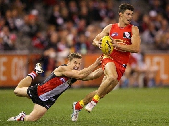 MELBOURNE, AUSTRALIA - AUGUST 25: Tom Curren of the Saints tackles Jaeger O'Meara of the Suns during the round 22 AFL match between the St Kilda Saints and the Gold Coast Suns at Etihad Stadium on August 25, 2013 in Melbourne, Australia. (Photo by Michael Dodge/Getty Images)