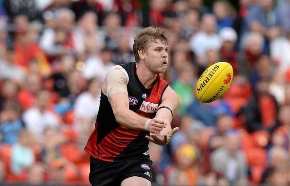 GOLD COAST, AUSTRALIA - AUGUST 22: Michael Hurley of the Bombers handballs during the round 21 AFL match between the Gold Coast Suns and the Essendon Bombers at Metricon Stadium on August 22, 2015 in Gold Coast, Australia. (Photo by Bradley Kanaris/Getty Images)