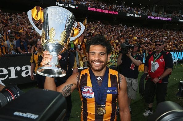 MELBOURNE, AUSTRALIA - OCTOBER 03: Cyril Rioli of the Hawks celebrates with the trophy after winning the 2015 AFL Grand Final match between the Hawthorn Hawks and the West Coast Eagles at Melbourne Cricket Ground on October 3, 2015 in Melbourne, Australia. (Photo by Quinn Rooney/Getty Images)