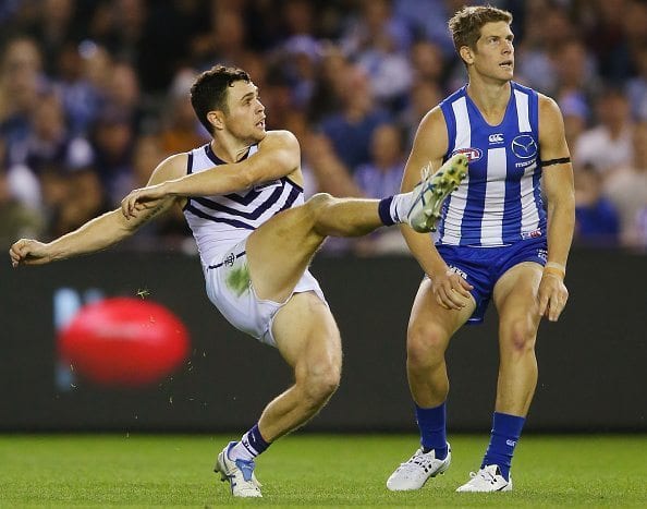 MELBOURNE, AUSTRALIA - APRIL 17: Hayden Ballantyne of the Dockers kicks the ball for a goal next to Nick Dal Santo of the Kangaroos during the Round 4 AFL match between North Melbourne v Fremantle at Etihad Stadium on April 17, 2016 in Melbourne, Australia. (Photo by Michael Dodge/Getty Images)