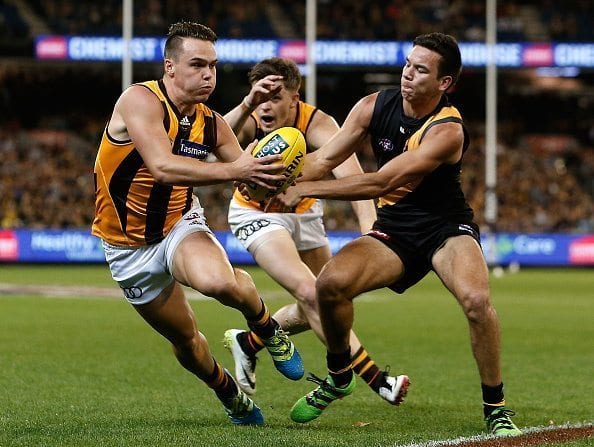 MELBOURNE, AUSTRALIA - MAY 6: Kieran Lovell of the Hawks evades the tackle of Daniel Rioli of the Tigers during the 2016 AFL Round 07 match between the Richmond Tigers and the Hawthorn Hawks at the Melbourne Cricket Ground, Melbourne on May 6, 2016. (Photo by Justine Walker/AFL Media)