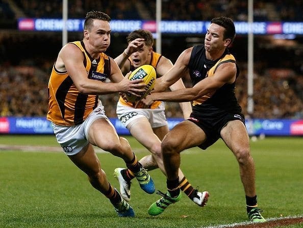 MELBOURNE, AUSTRALIA - MAY 6: Kieran Lovell of the Hawks evades the tackle of Daniel Rioli of the Tigers during the 2016 AFL Round 07 match between the Richmond Tigers and the Hawthorn Hawks at the Melbourne Cricket Ground, Melbourne on May 6, 2016. (Photo by Justine Walker/AFL Media)