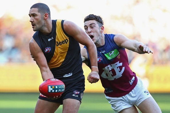 MELBOURNE, AUSTRALIA - JUNE 25: Shaun Grigg of the Tigers handballs whilst being tackled by Daniel McStay of the Lions during the round 14 AFL match between the Richmond Tigers and the Brisbane Lions at Melbourne Cricket Ground on June 25, 2016 in Melbourne, Australia. (Photo by Quinn Rooney/Getty Images)