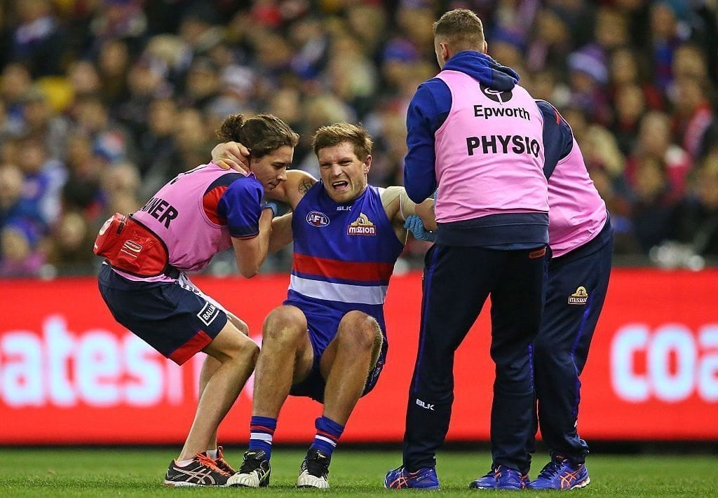 MELBOURNE, AUSTRALIA - JULY 23: Jack Redpath of the Bulldogs leaves the field injured during the round 18 AFL match between the Western Bulldogs and the St Kilda Saints at Etihad Stadium on July 23, 2016 in Melbourne, Australia. (Photo by Scott Barbour/Getty Images)