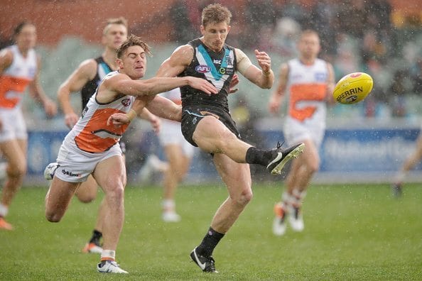 ADELAIDE, AUSTRALIA - JULY 24: Stephen Coniglio of the Giants tackles Hamish Hartlett of the Power as he kicks the ball during the round 18 AFL match between the Port Adelaide Power and the Greater Western Sydney Giants at Adelaide Oval on July 24, 2016 in Adelaide, Australia. (Photo by Darrian Traynor/Getty Images)