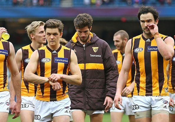 MELBOURNE, AUSTRALIA - AUGUST 06: Ben Stratton and the Hawks leave the field after losing the round 20 AFL match between the Melbourne Demons and the Hawthorn Hawks at Melbourne Cricket Ground on August 6, 2016 in Melbourne, Australia. (Photo by Scott Barbour/Getty Images)