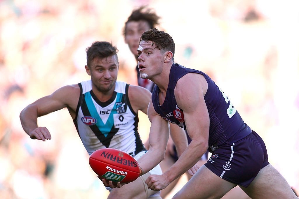 PERTH, AUSTRALIA - JUNE 18: Lachie Neale of the Dockers looks to handball during the round 13 AFL match between the Fremantle Dockers and the Port Adelaide Power at Domain Stadium on June 18, 2016 in Perth, Australia. (Photo by Paul Kane/Getty Images)