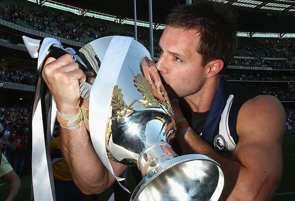 MELBOURNE, AUSTRALIA - OCTOBER 02: Nathan Brown of the Magpies kisses the Premiership Cup after the Magpies won the AFL Grand Final Replay match between the Collingwood Magpies and the St Kilda Saints at Melbourne Cricket Ground on October 2, 2010 in Melbourne, Australia. (Photo by Quinn Rooney/Getty Images)