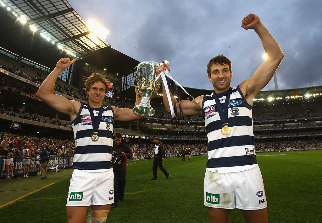 MELBOURNE, AUSTRALIA - OCTOBER 01: Mitch Duncan and Corey Enright of the Cats celebrate with the Premiership Cup after winning the 2011 AFL Grand Final match between the Collingwood Magpies and the Geelong Cats at Melbourne Cricket Ground on October 1, 2011 in Melbourne, Australia. (Photo by Mark Dadswell/Getty Images)