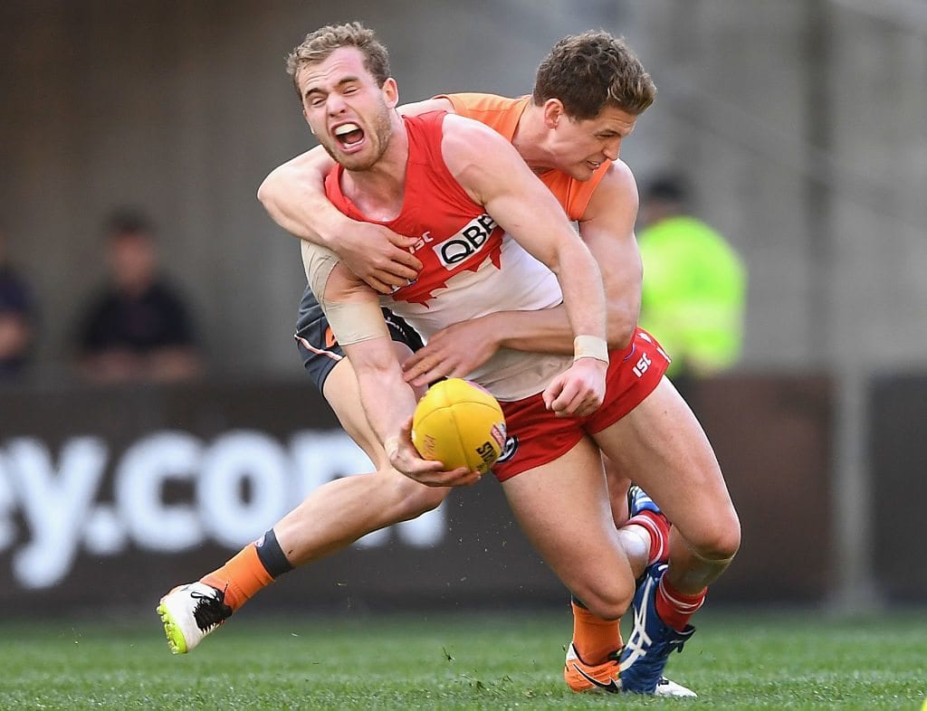 SYDNEY, AUSTRALIA - SEPTEMBER 10: Tom Mitchell of the Swans handballs whilst being tackled Jacob Hopper of the Giants during the AFL 1st Qualifying Final match between the Sydney Swans and the Greater Western Sydney Giants at ANZ Stadium on September 10, 2016 in Sydney, Australia. (Photo by Quinn Rooney/Getty Images)