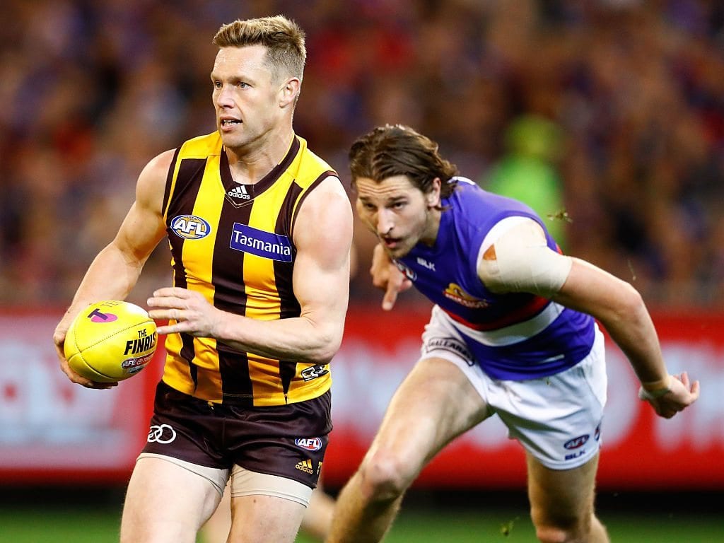 MELBOURNE, AUSTRALIA - SEPTEMBER 16: Sam Mitchell of the Hawks in action ahead of Marcus Bontempelli of the Bulldogs during the 2016 AFL Second Semi Final match between the Hawthorn Hawks and the Western Bulldogs at the Melbourne Cricket Ground on September 16, 2016 in Melbourne, Australia. (Photo by Adam Trafford/AFL Media/Getty Images)